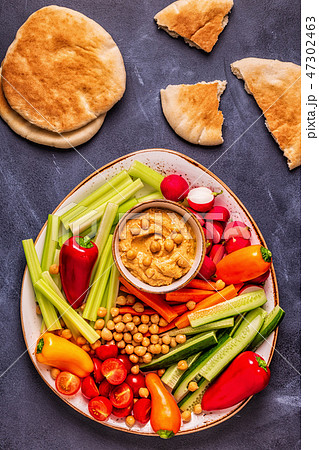 Hummus with various fresh raw vegetables. Hummus with various fresh raw vegetables. 47302463