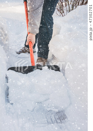 Man clearing snow by shovel after snowfall. Man clearing snow by shovel after snowfall. 47302701