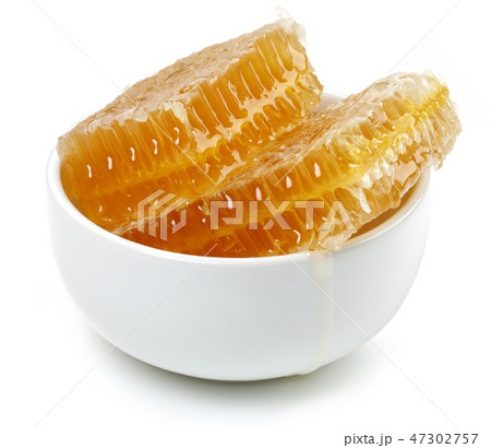 Honeycomb in white bowl on white background Honeycomb in white bowl on white background 47302757