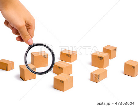 Magnifying glass is looking at the Cardboard boxes Magnifying glass is looking at the Cardboard boxes 47303604