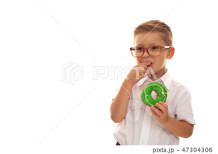 Little cute boy in a white shirt and glasses Little cute boy in a white shirt and glasses 47304306