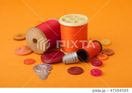 closeup of sewing set on orange background closeup of sewing set on orange background 47304565
