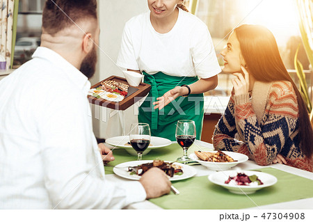 Romantic dinner happy men and women in restaurant Romantic dinner happy men and women in restaurant 47304908