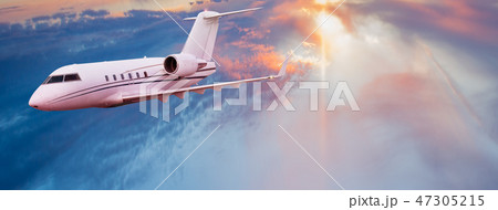 Small private jetplane flying above beautiful clouds. 47305215