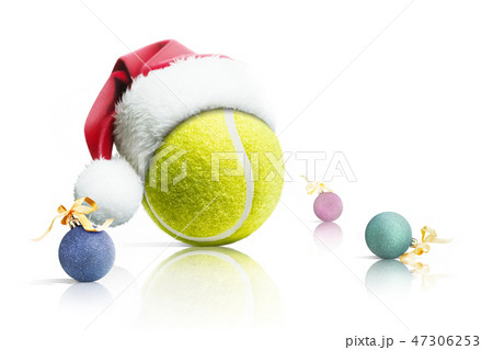Christmas tennis. Tennis ball in Santa hat Christmas toys on white background. Isolated 47306253
