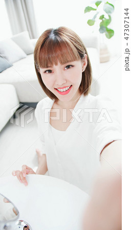 woman selfie with teeth retainer 47307144