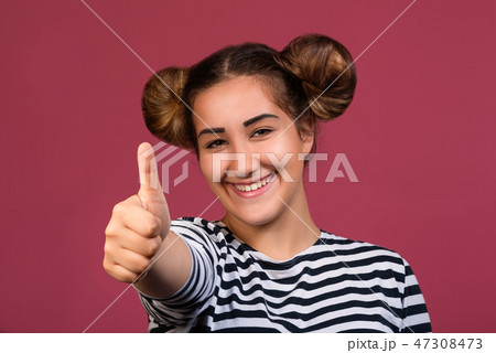 Smiling girl making ok hand gesture Smiling girl making ok hand gesture 47308473
