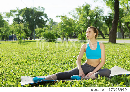 Girl practicing stretching exercises Girl practicing stretching exercises 47308949