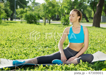 Girl practicing stretching exercises Girl practicing stretching exercises 47309001