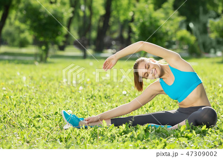 Girl practicing stretching exercises Girl practicing stretching exercises 47309002