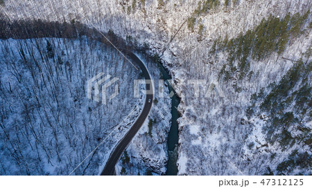Aerial top down photo of road, river, mountains in Lago-Naki, Russia. Aerial top down photo of road, river, mountains in Lago-Naki, Russia. 47312125