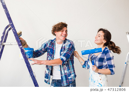 People, renovation and repair concept - Portrait of lovely couple doing redecoration in apartment 47312806