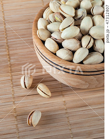 Pistachios in a wooden bowl. Close up. Pistachios in a wooden bowl. Close up. 47312807