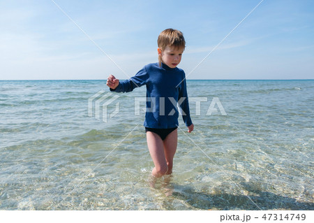 Cute boy on beach of sea Cute boy on beach of sea 47314749