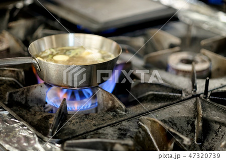 Preparation of soup in silver pan on gas. Preparation of soup in silver pan on gas. 47320739