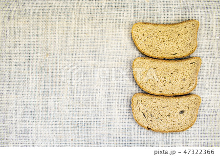 Slice whole wheat bread on natural fabric 47322366