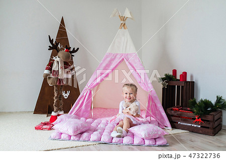 Little girl playing in a tent. Little girl playing in a tent. 47322736