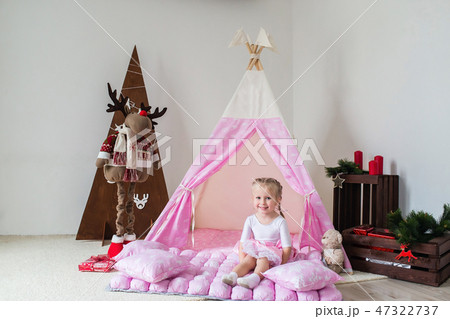 Little girl playing in a tent. Little girl playing in a tent. 47322737