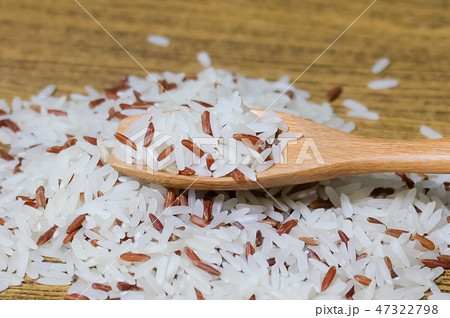 Brown and White Jasmine Rice on Wooden Spoon 47322798