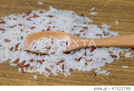 Brown and White Jasmine Rice on Wooden Spoon 47322799