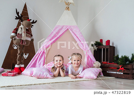 Two little girls play in a teepee Two little girls play in a teepee 47322819