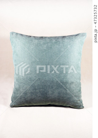 Vibrant teal pillow on a white velvet background Vibrant teal pillow on a white velvet background 47325732