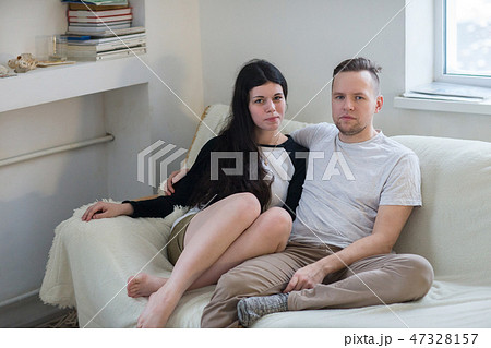 Couple at home relaxing in sofa Couple at home relaxing in sofa 47328157
