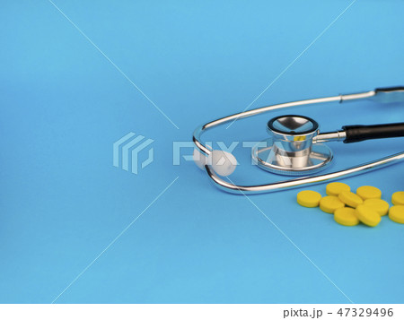 Black stethoscope for doctor and yellow pills Black stethoscope for doctor and yellow pills 47329496