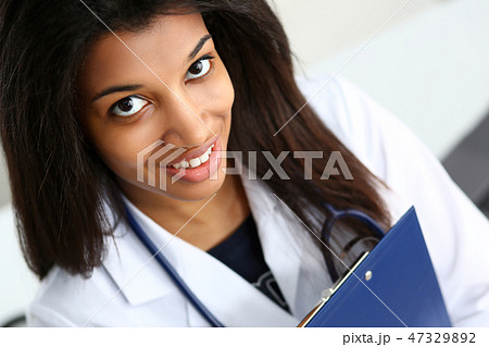 Beautiful black smiling female doctor at 47329892