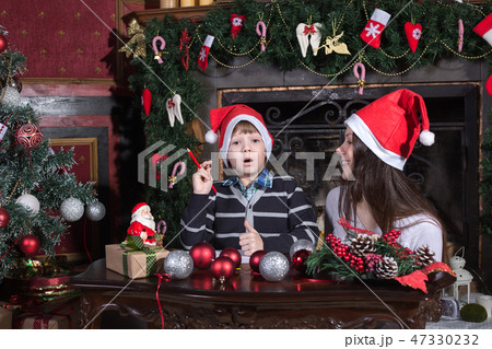 mother and son writing letter to Santa 47330232