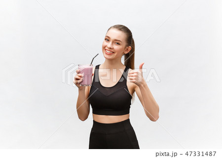 young happy woman with healthy diet shake drinking for sport and fitness. young happy woman with healthy diet shake drinking for sport and fitness. 47331487
