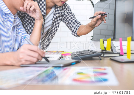 Two colleagues creative graphic designer working on color select 47331781