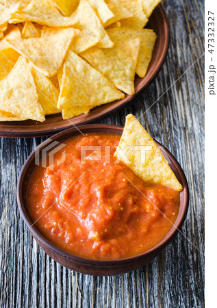 Nachos corn chips, spicy tomato and cheese sauces. Nachos corn chips, spicy tomato and cheese sauces. 47332327