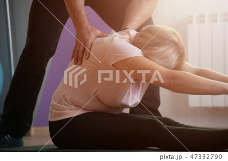 Aged woman engaged in stretching ligaments Aged woman engaged in stretching ligaments 47332790