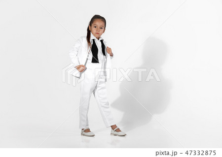 fashion little girl model in a white suit and bow tie 47332875