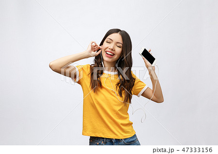 Beautiful asian girl with professional makeup and stylish hairstyle singing and dancing while Beautiful asian girl with professional makeup and stylish hairstyle singing and dancing while 47333156