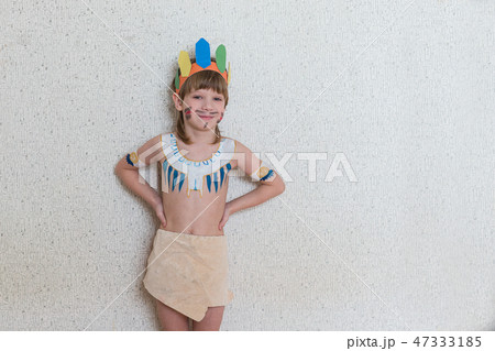 Blond boy playing injun 47333185