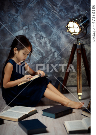 cute little girl is reading a book. cute little girl is reading a book. 47333186