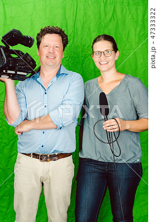 Crew of reporter and cameraman posing in the studio Crew of reporter and cameraman posing in the studio 47333322