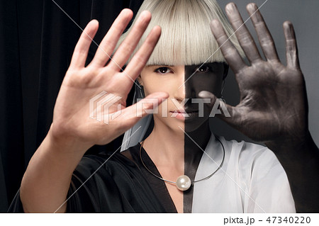 Portrait of a girl half black and white. Half-breed, mixing races, African and european. 47340220