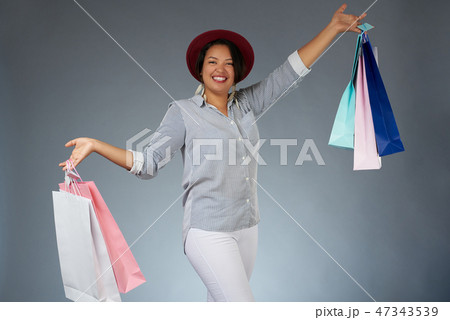 Happy woman with colorful shopping bags Happy woman with colorful shopping bags 47343539