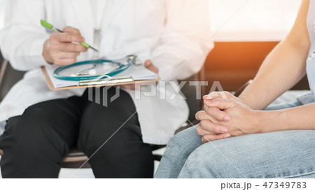 Doctor consulting stressful woman patient Doctor consulting stressful woman patient 47349783