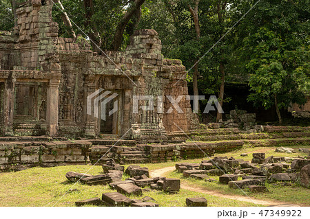 Stone temple with fallen blocks covering lawn Stone temple with fallen blocks covering lawn 47349922
