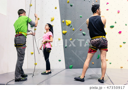 Woman preparing for wall climbing 47350917