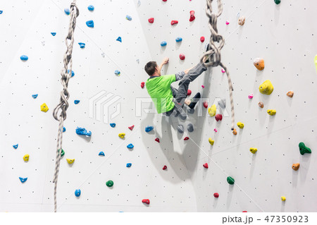 Man climbing wall 47350923