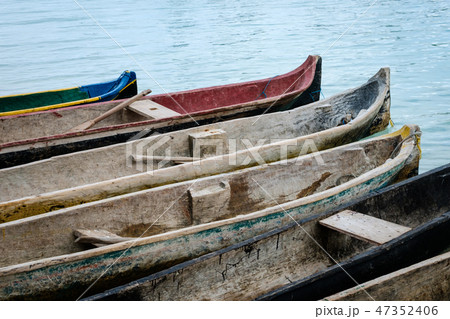 traditional wooden canoe boats at waterside , padd 47352406