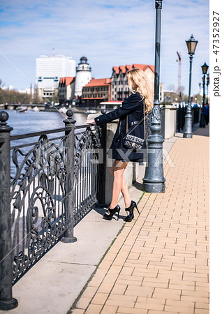 Beautiful girl walking in the street of city 47352927