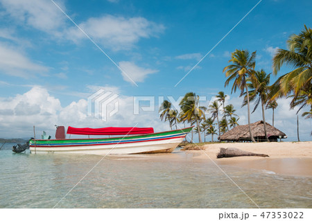 boat on island beach with palm tree and bungalow boat on island beach with palm tree and bungalow 47353022
