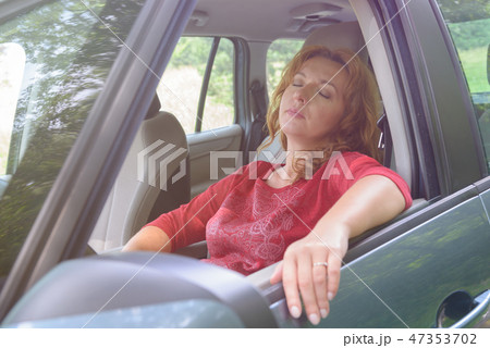 Woman is resting in the car Woman is resting in the car 47353702