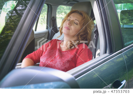 Woman is resting in the car Woman is resting in the car 47353703